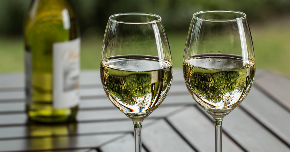 Two chilled glasses of dry white wine on an outdoor patio table in Sonoma County